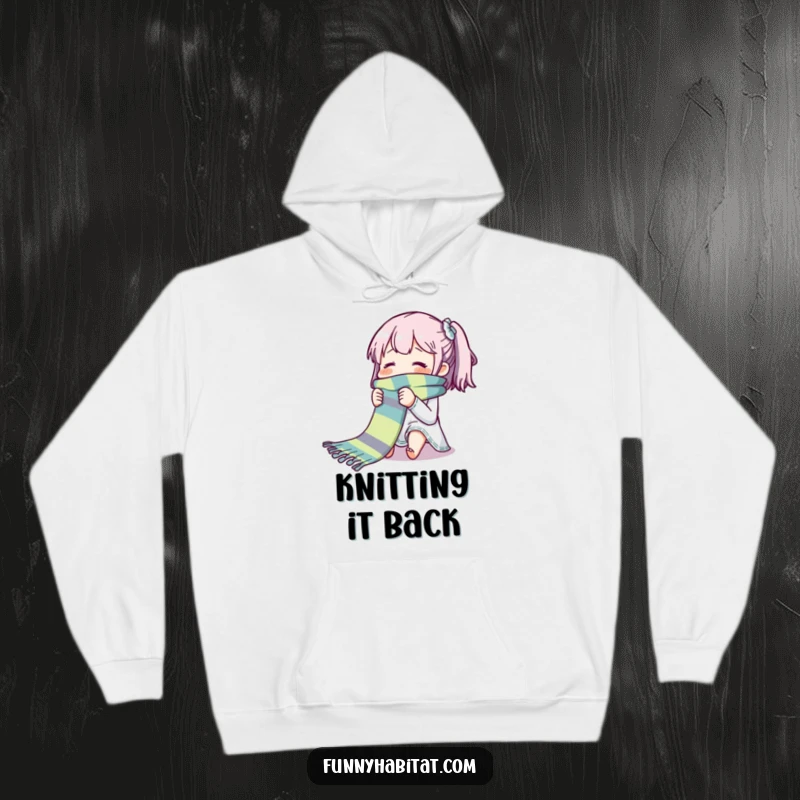 Funny hoodie depicting a character blissfully knitting a long, colorful scarf; warm and humorous apparel for crafters.